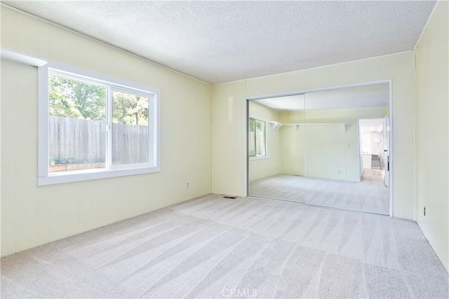 4955 Arizona Ave, Atascadero, CA 93422 - unfurnished bedroom featuring carpet floors, a textured ceiling, and a closet