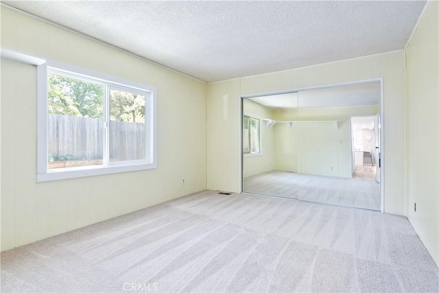 4955 Arizona Ave, Atascadero, CA 93422 - unfurnished bedroom featuring carpet floors, a textured ceiling, and a closet