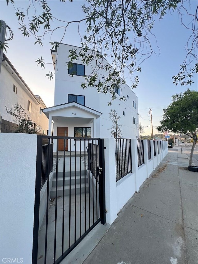 4268 Capistrano Way E, Los Angeles, CA 90063 - view of front facade with a gate, stucco siding, and a fenced front yard