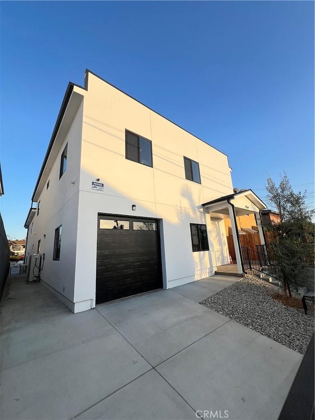 4264 Capistrano Way E, Los Angeles, CA 90063 - modern home with an attached garage, concrete driveway, and stucco siding