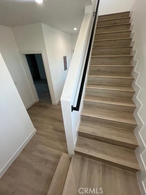 1217 E 22nd St, Los Angeles, CA 90011 - staircase with wood finished floors and recessed lighting