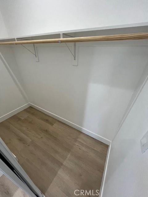 1217 E 22nd St, Los Angeles, CA 90011 - walk in closet featuring wood finished floors