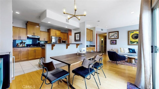 4821 Bakman Ave Unit 405, North Hollywood, CA 91601 - dining area with a chandelier and light wood-style flooring
