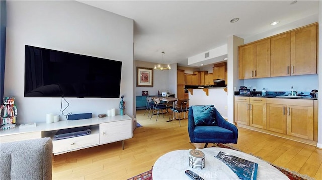 4821 Bakman Ave Unit 405, North Hollywood, CA 91601 - living room featuring light wood-type flooring, a chandelier, and recessed lighting
