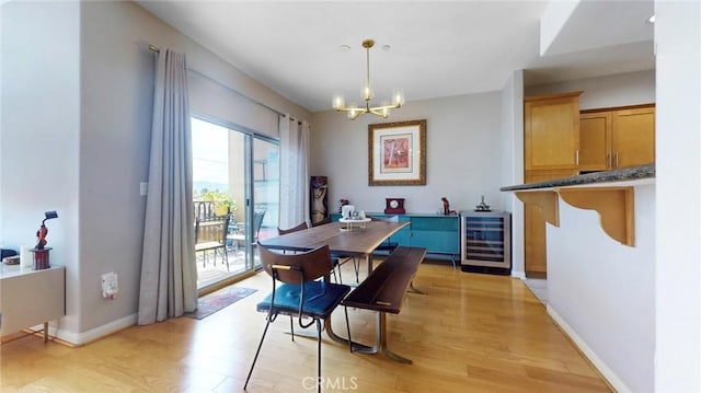 4821 Bakman Ave Unit 405, North Hollywood, CA 91601 - dining area featuring wine cooler, a chandelier, and light wood finished floors