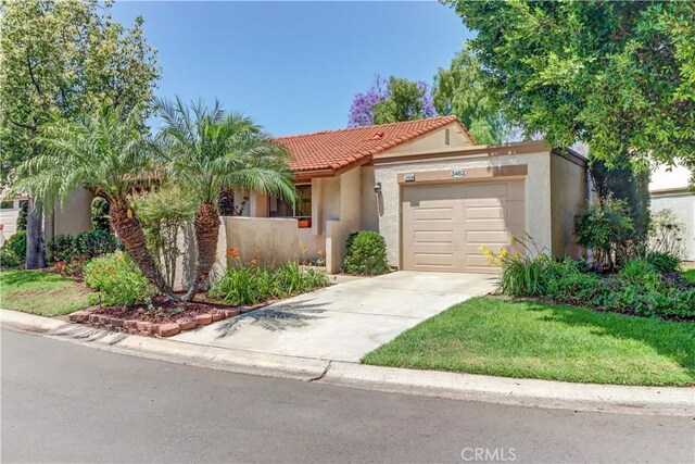 3463 Bahia Blanca W Unit B, Laguna Woods, CA 92637 - view of front of house with a garage, stucco siding, driveway, and a tiled roof