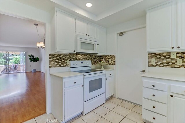 3463 Bahia Blanca W Unit B, Laguna Woods, CA 92637 - kitchen with white appliances, light countertops, white cabinetry, and backsplash