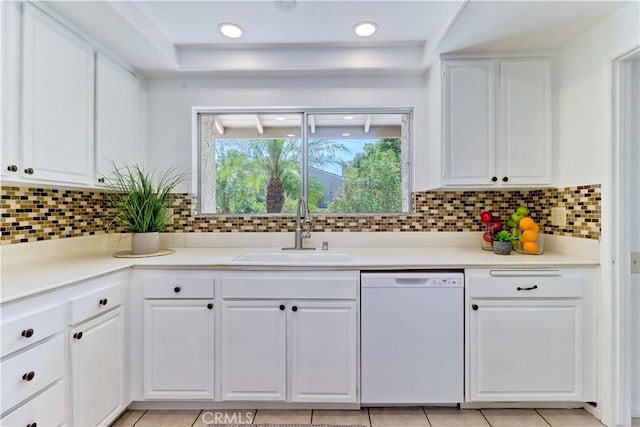 3463 Bahia Blanca W Unit B, Laguna Woods, CA 92637 - kitchen with white dishwasher, white cabinets, a raised ceiling, and decorative backsplash