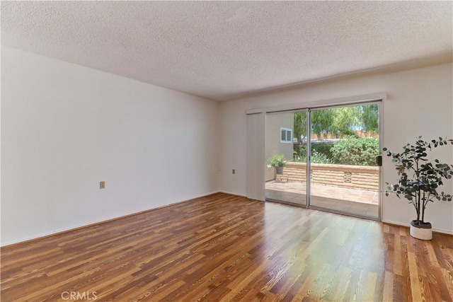 3463 Bahia Blanca W Unit B, Laguna Woods, CA 92637 - spare room with wood finished floors and a textured ceiling