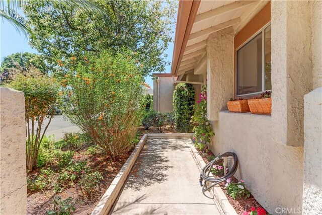 3463 Bahia Blanca W Unit B, Laguna Woods, CA 92637 - view of property exterior featuring stucco siding and a bocce ball area