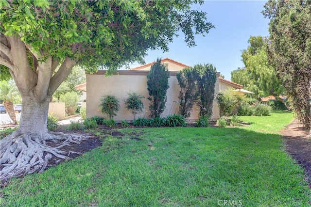 3463 Bahia Blanca W Unit B, Laguna Woods, CA 92637 - view of home's exterior with a yard and stucco siding
