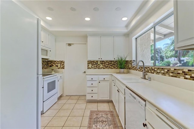 3463 Bahia Blanca W Unit B, Laguna Woods, CA 92637 - kitchen with white appliances, backsplash, white cabinets, light countertops, and recessed lighting