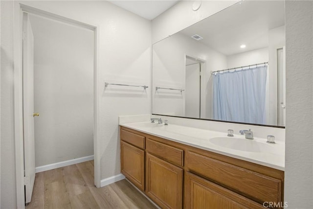 24538 Meadow Grass Way, Moreno Valley, CA 92557 - bathroom featuring wood finished floors, double vanity, and curtained shower