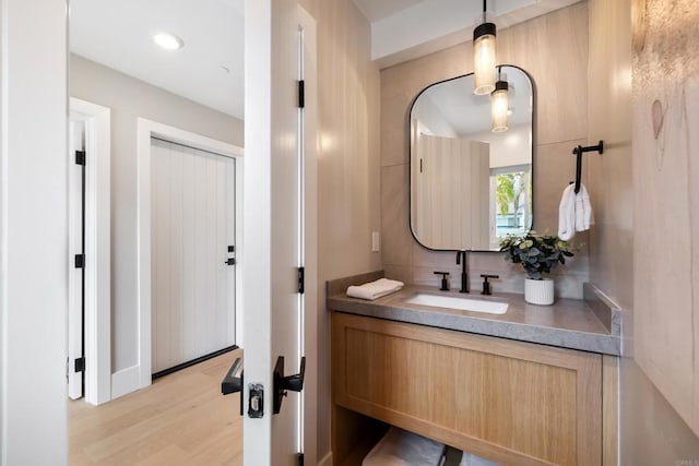 3586 Garfield St, Carlsbad, CA 92008 - bathroom featuring vanity, wood finished floors, and tasteful backsplash