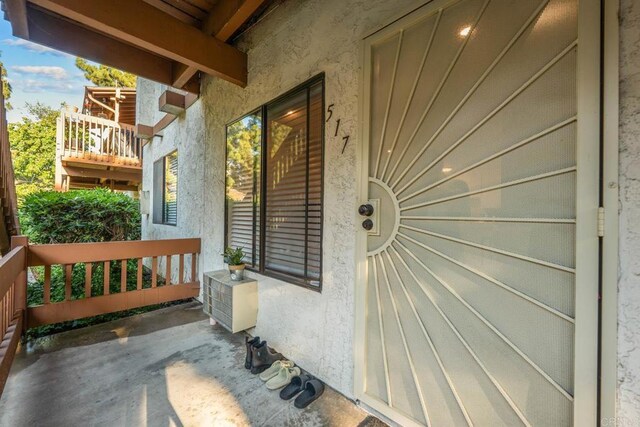 6354 Rancho Mission Rd Unit 517, San Diego, CA 92108 - doorway to property with stucco siding