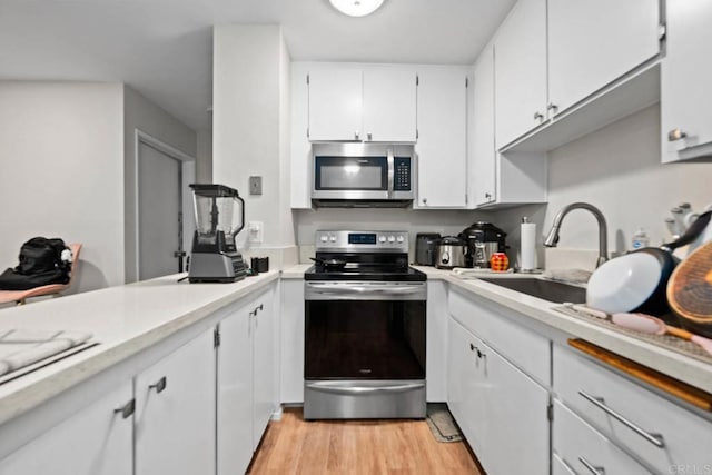 6354 Rancho Mission Rd Unit 517, San Diego, CA 92108 - kitchen with appliances with stainless steel finishes, light countertops, white cabinets, and light wood finished floors