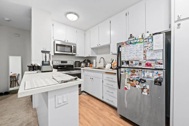 6354 Rancho Mission Rd Unit 517, San Diego, CA 92108 - kitchen with appliances with stainless steel finishes, white cabinetry, light countertops, and a peninsula