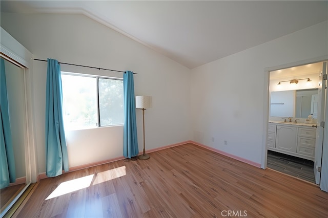 20004 Kent Ln, Canyon Country, CA 91351 - unfurnished bedroom with lofted ceiling, light wood-style floors, and ensuite bath