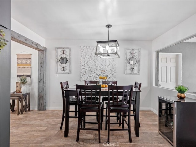 17789 Sycamore St, Hesperia, CA 92345 - dining area with a chandelier, wood finished floors, and wine cooler