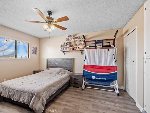 17789 Sycamore St, Hesperia, CA 92345 - bedroom featuring a textured ceiling, wood finished floors, ceiling fan, and a closet