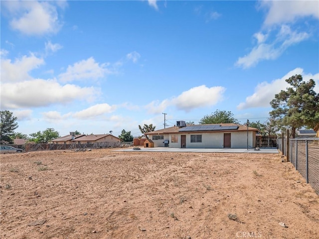 17789 Sycamore St, Hesperia, CA 92345 - view of front facade with a patio, solar panels, and a fenced backyard