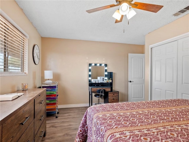 17789 Sycamore St, Hesperia, CA 92345 - bedroom featuring wood finished floors, a textured ceiling, a closet, and ceiling fan