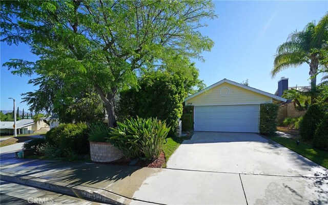 27768 Crookshank Dr, Saugus, CA 91350 - view of property hidden behind natural elements featuring a garage and driveway