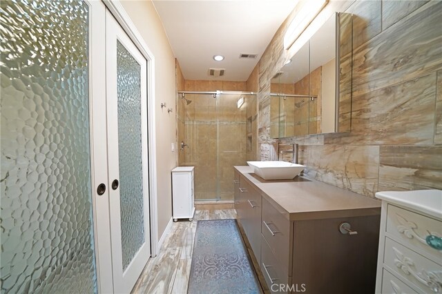 27768 Crookshank Dr, Saugus, CA 91350 - full bathroom featuring vanity, a stall shower, and wood finished floors