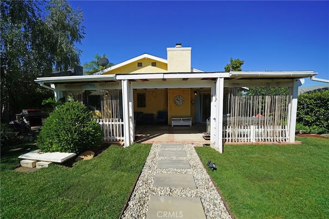 27768 Crookshank Dr, Saugus, CA 91350 - view of front of home with a chimney, a front yard, and a patio area