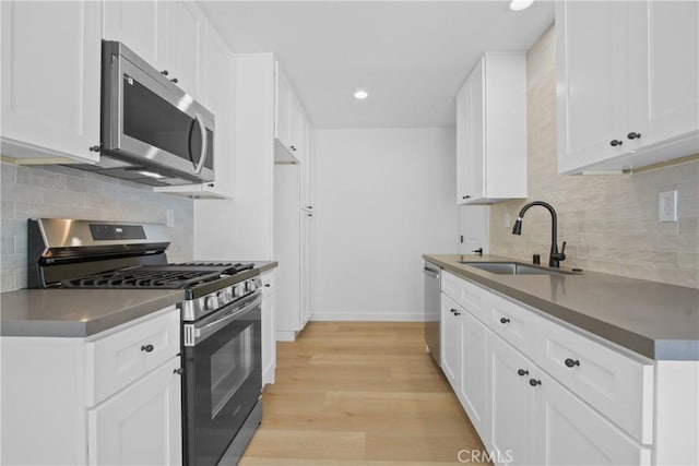 22983 Via Cereza Unit 3B, Mission Viejo, CA 92691 - kitchen featuring appliances with stainless steel finishes, tasteful backsplash, recessed lighting, light wood-style flooring, and white cabinets