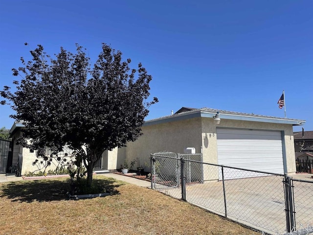 1195 Ilexey Ave, San Diego, CA 92154 - view of home's exterior featuring stucco siding, a garage, a gate, and driveway