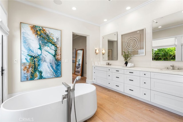 30 Catalina Vista Rd, Ladera Ranch, CA 92694 - full bath with double vanity, crown molding, wood finished floors, a freestanding tub, and recessed lighting