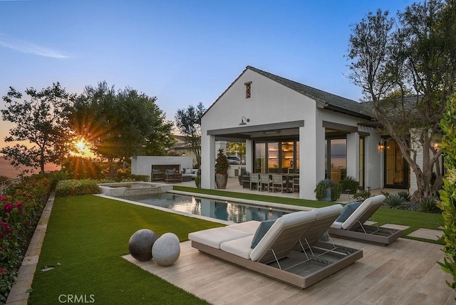 30 Catalina Vista Rd, Ladera Ranch, CA 92694 - back of property at dusk with an outdoor living space, a patio, stucco siding, a yard, and an outdoor kitchen