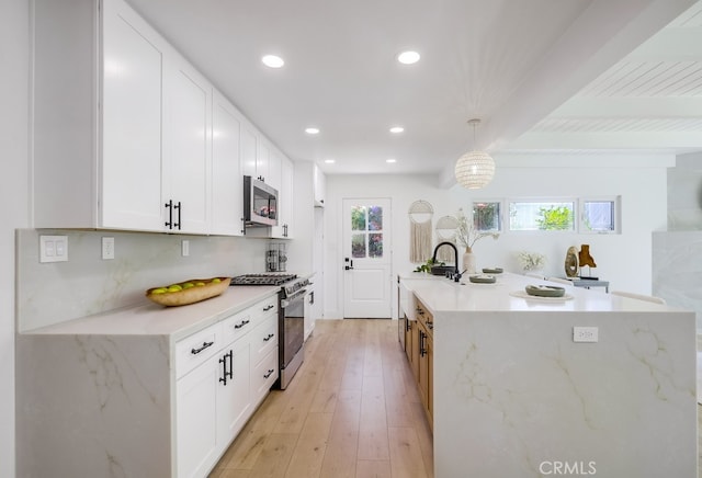 4532 Zella Ln, Yorba Linda, CA 92886 - kitchen with stainless steel appliances, beamed ceiling, recessed lighting, white cabinetry, and light wood finished floors