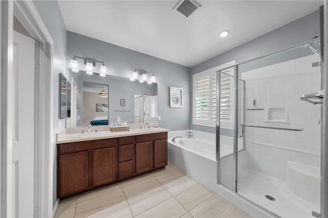 4040 Quartzite Ln, San Bernardino, CA 92407 - full bathroom featuring a stall shower, a bath, double vanity, and tile patterned floors