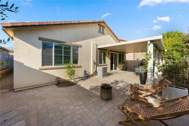 4040 Quartzite Ln, San Bernardino, CA 92407 - rear view of house featuring stucco siding and a patio area