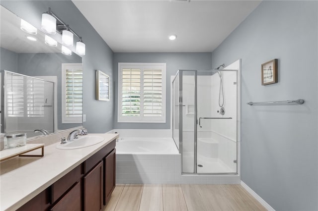 4040 Quartzite Ln, San Bernardino, CA 92407 - bathroom with a shower stall, a bath, and vanity