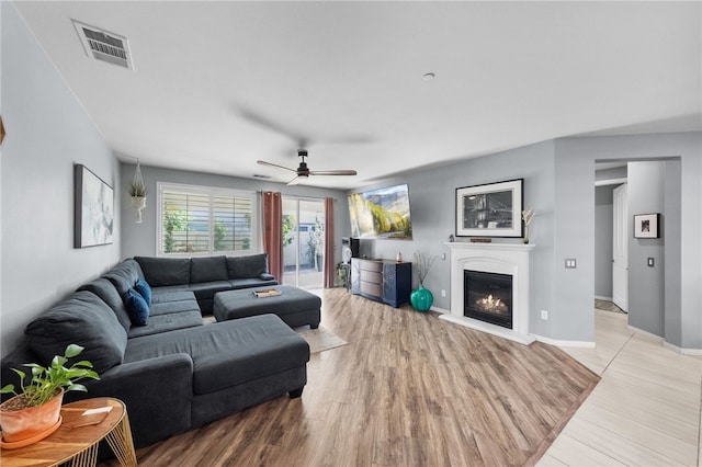 4040 Quartzite Ln, San Bernardino, CA 92407 - living room featuring a ceiling fan, a glass covered fireplace, and light wood-type flooring