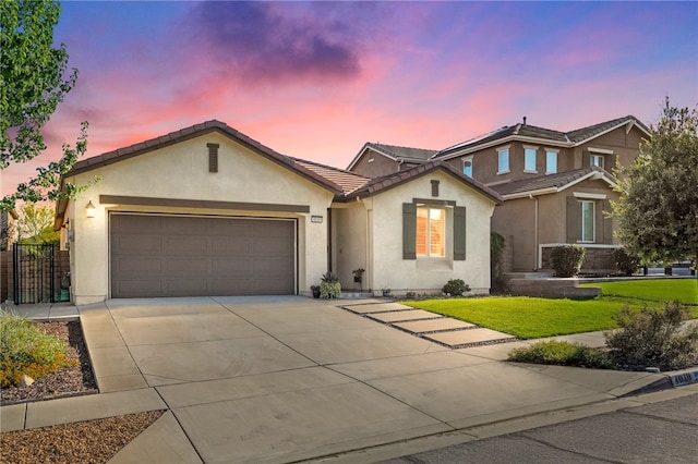 4040 Quartzite Ln, San Bernardino, CA 92407 - view of front of property featuring a tile roof, concrete driveway, stucco siding, and an attached garage