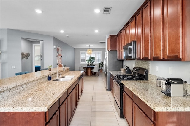 4040 Quartzite Ln, San Bernardino, CA 92407 - kitchen featuring appliances with stainless steel finishes, light tile patterned floors, a large island, light stone countertops, and recessed lighting
