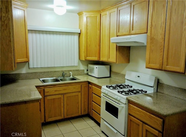 12843 Columbia Way, Downey, CA 90242 - kitchen with white appliances, under cabinet range hood, and light tile patterned floors