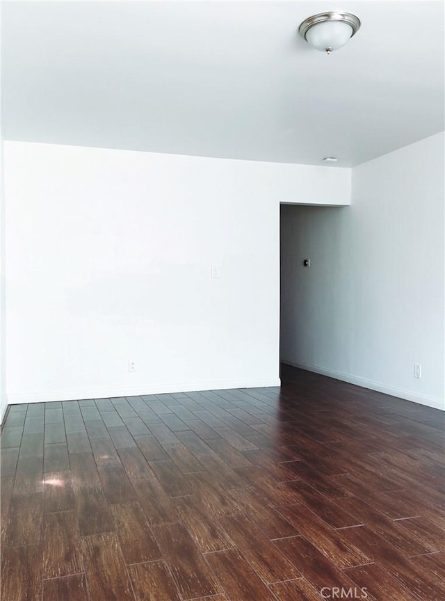 12843 Columbia Way, Downey, CA 90242 - empty room featuring dark wood-style floors and baseboards