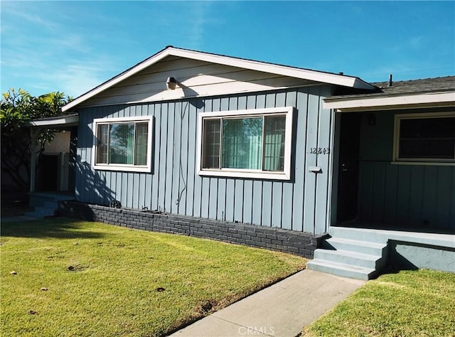 12843 Columbia Way, Downey, CA 90242 - view of front of house with a front lawn and board and batten siding