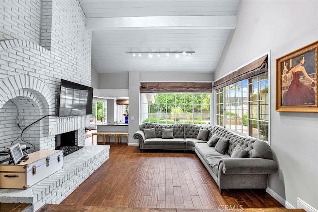 17437 Tarzana St, Encino, CA 91316 - living room with a brick fireplace, wood finished floors, track lighting, plenty of natural light, and wood ceiling
