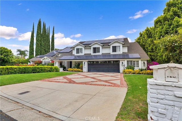 17437 Tarzana St, Encino, CA 91316 - traditional home featuring a front yard, concrete driveway, roof mounted solar panels, an attached garage, and stucco siding