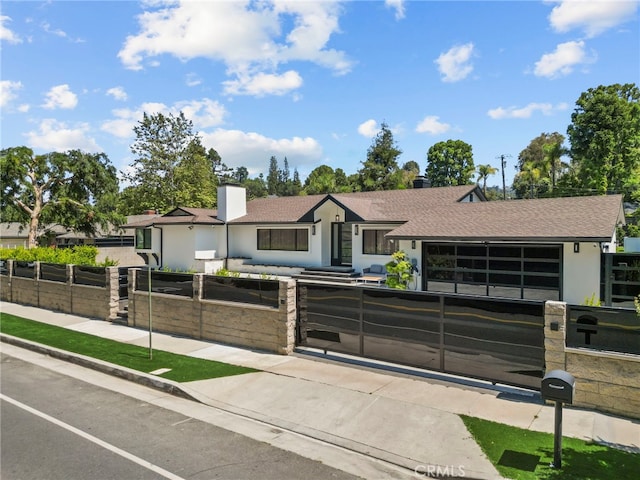 16810 Adlon Rd, Encino, CA 91436 - ranch-style home featuring a fenced front yard, a shingled roof, stucco siding, a chimney, and an attached garage