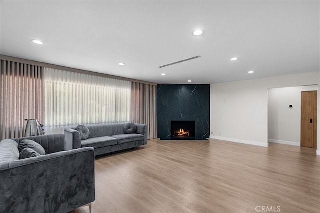 16810 Adlon Rd, Encino, CA 91436 - living room with light wood-type flooring, a premium fireplace, and recessed lighting