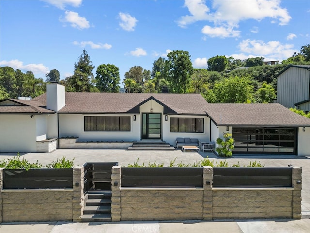 16810 Adlon Rd, Encino, CA 91436 - view of front of home with an outdoor hangout area, a fenced front yard, roof with shingles, and a patio area