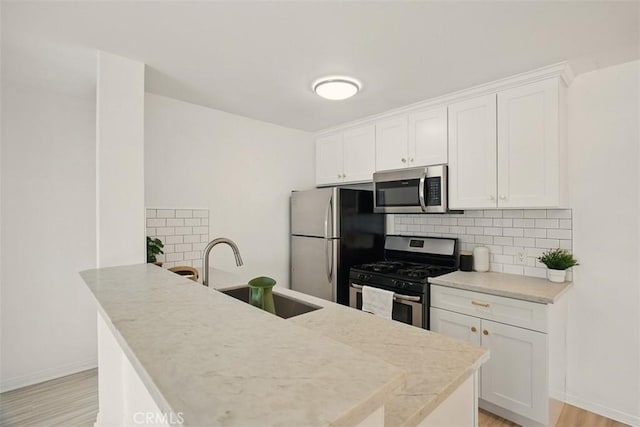 4727 W 147th St Unit 133, Lawndale, CA 90260 - kitchen with stainless steel appliances, tasteful backsplash, and white cabinets