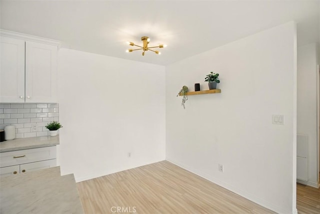 4727 W 147th St Unit 133, Lawndale, CA 90260 - unfurnished dining area with light wood-type flooring and a chandelier